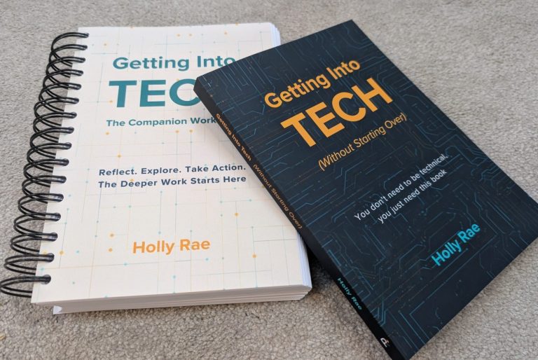 two books, one dark cover with the getting into tech title and one spiral bound with the companion workbook title