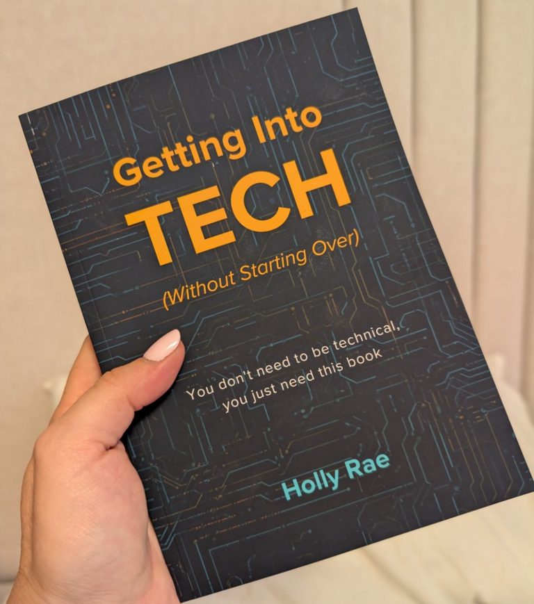 a left hand holding the dark cover book of getting into tech (without starting over) 